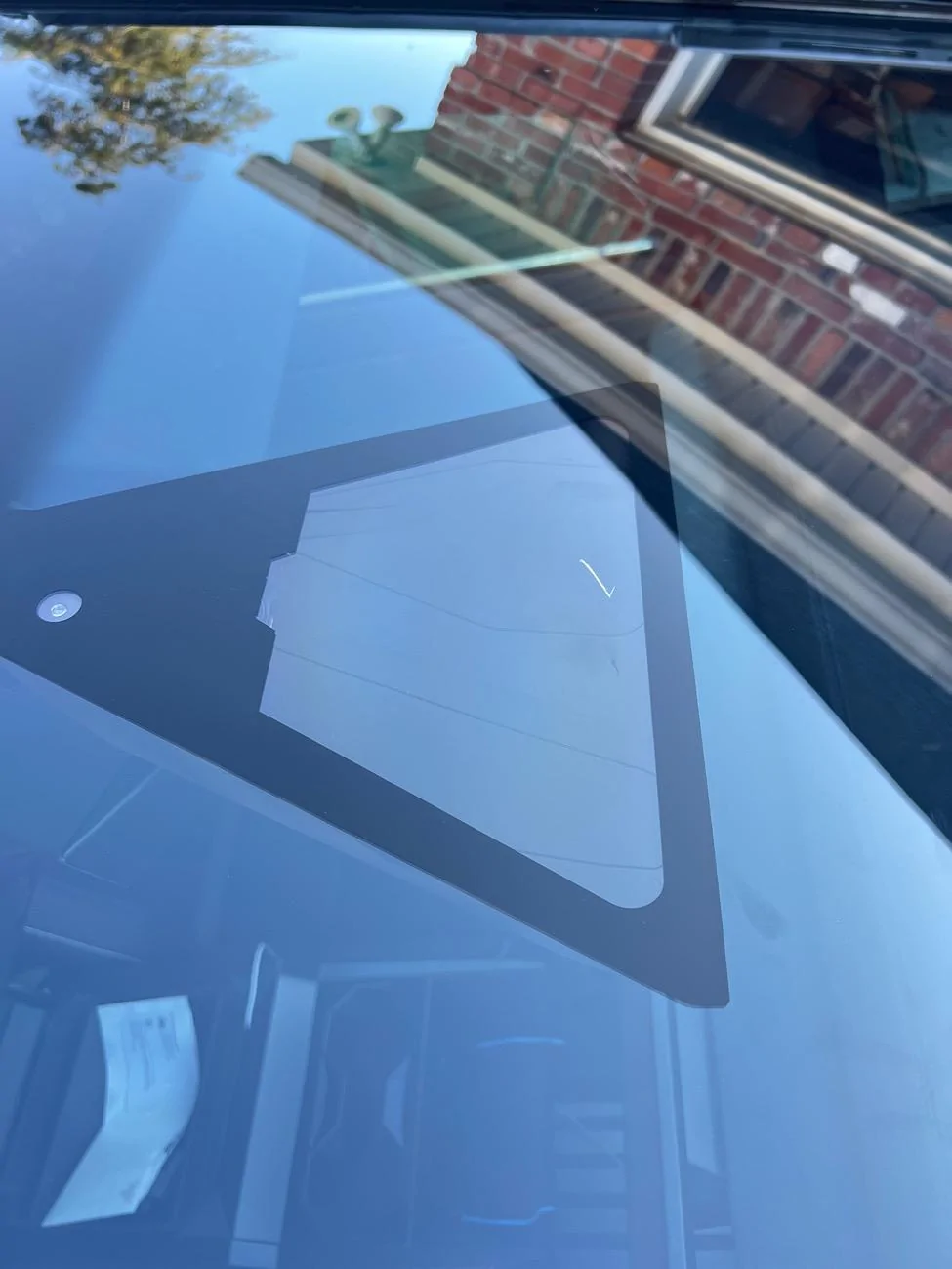 Tesla Roadster 2nd gen Leaf between window and rear view mirror cover. IMG_0455